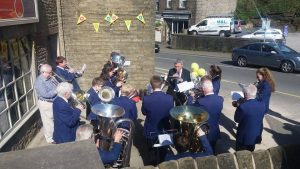 Diggle B play outside Allegro Optical Opticians in Meltham